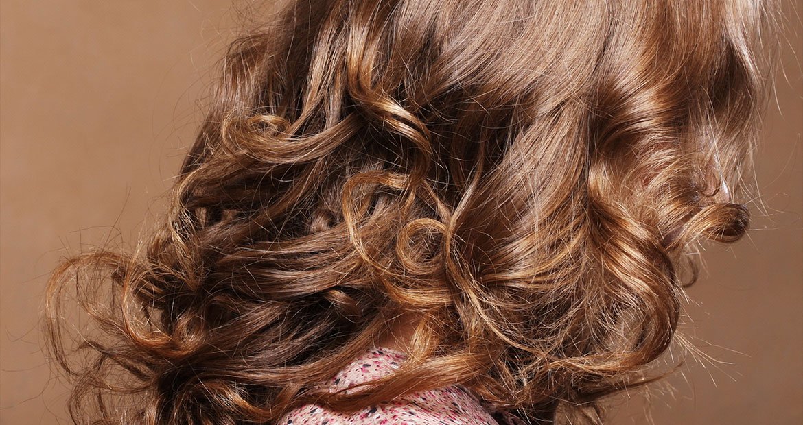 Pessoa com cabelo chocolate dourado cacheado